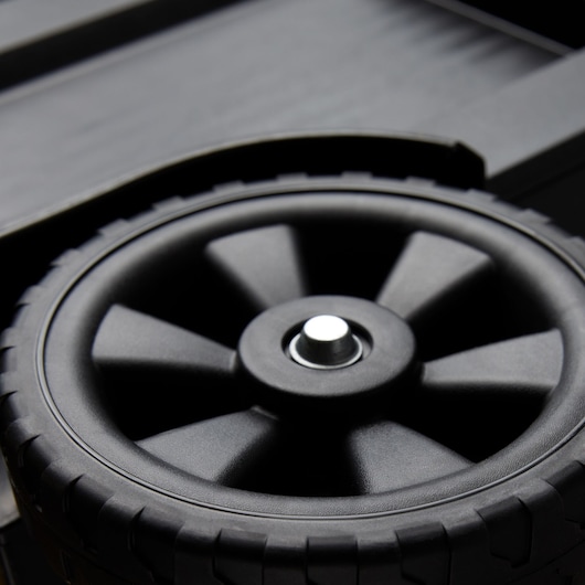 Close-up photo of STANLEY 020800R tool box black plastic wheel with textured rim.