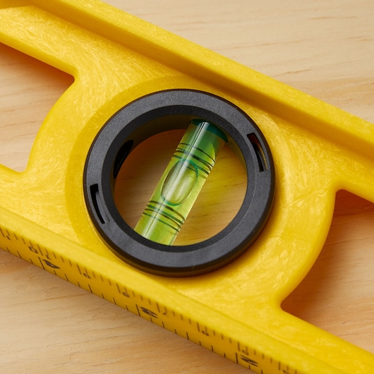 STANLEY 42-468 yellow spirit level close-up showing bubble vial and measurement markings.