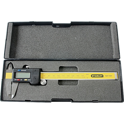 Stanley digital caliper SKU 78-440LA in a black foam case, yellow ruler, flat-lay white background.