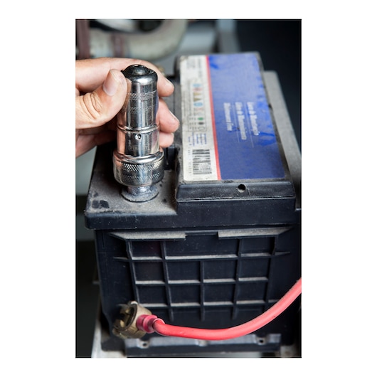 Photo of STANLEY 79-047 socket wrench being used on a car battery terminal, close-up view.