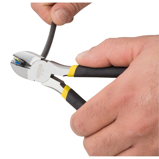 Stanley 90-162LA diagonal cutting pliers cutting a cable, close-up photo with white background.