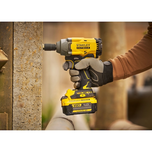 Stanley SBW920M2K cordless impact driver in use, yellow and black, close-up side angle.