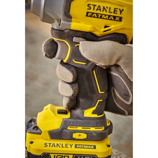 Photo of STANLEY SBW920M2K Fatmax cordless brushless drill held by gloved hand, close-up side view.