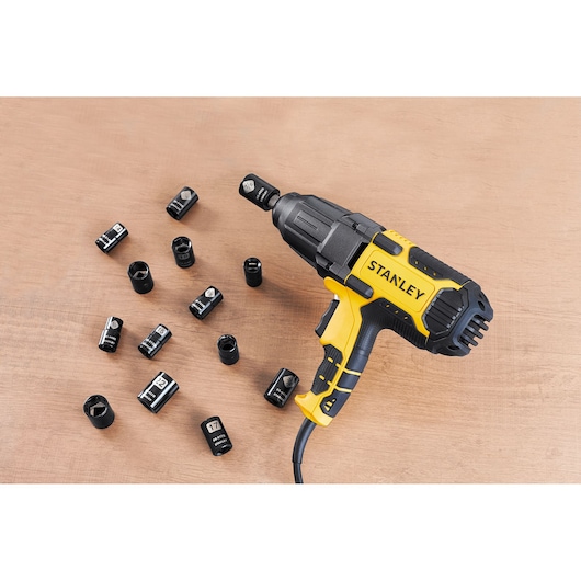 STANLEY SIW901-B2 impact wrench with sockets on wood surface, angled view.