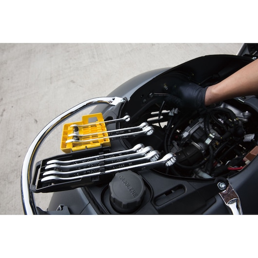 STANLEY STMT78099-8 wrench set with yellow and black tray on motorcycle engine during maintenance.