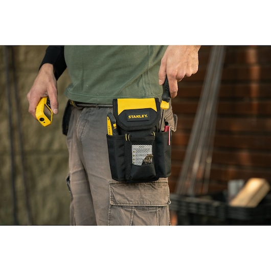 Photo of STANLEY STST509104LA tool pouch on belt with tools, shown in use outdoors.