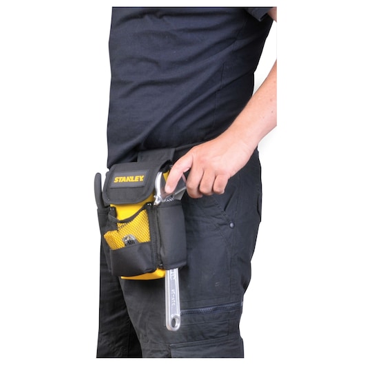 STANLEY STST509104LA tool pouch attached to waist, black and yellow, holding hand tools.